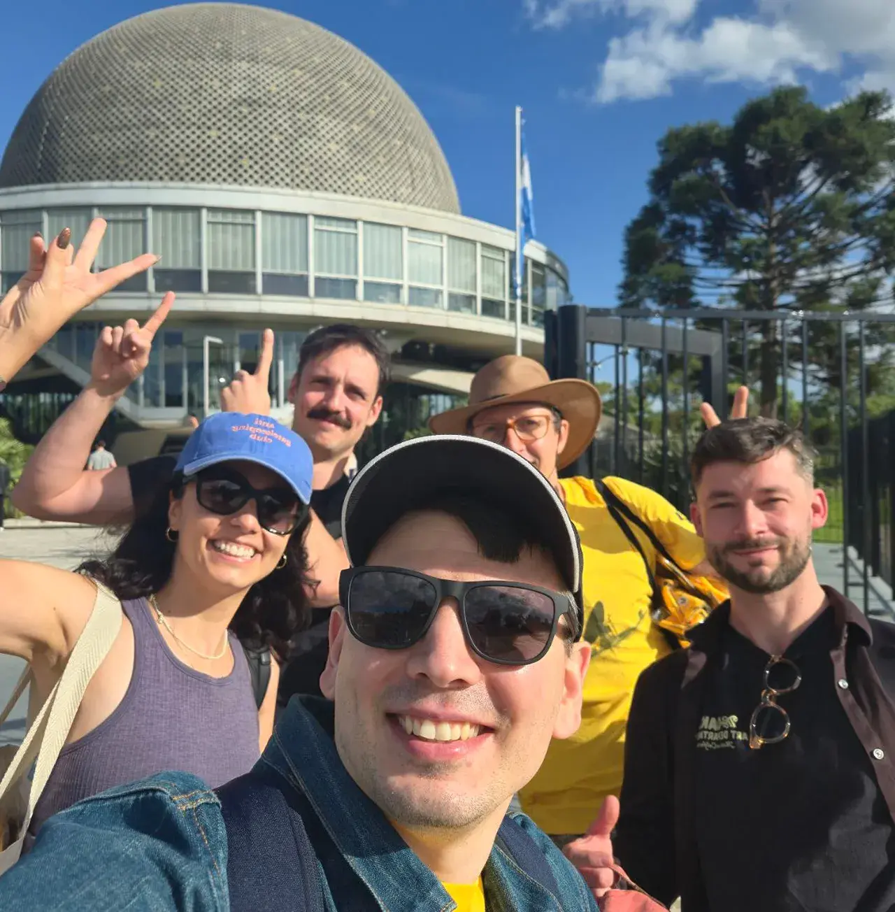 SpaceComputer team selfie in front of the planetarium